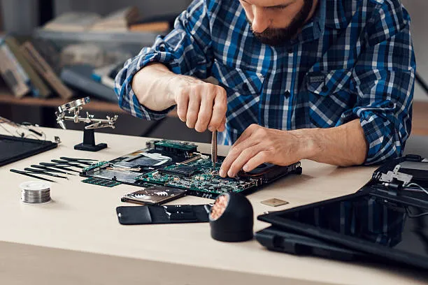 Zoo Computer Repairs technician repairing a laptop motherboard